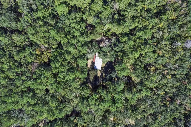 an aerial view of a houses with a yard
