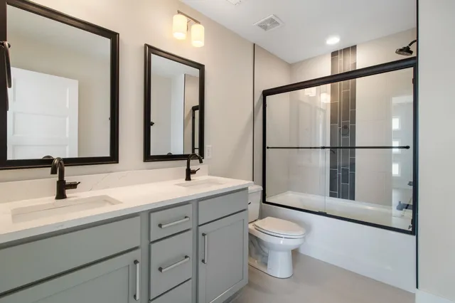a bathroom with a toilet a sink and a mirror
