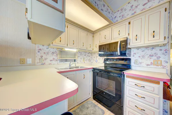 a kitchen with stainless steel appliances a stove a sink and a microwave