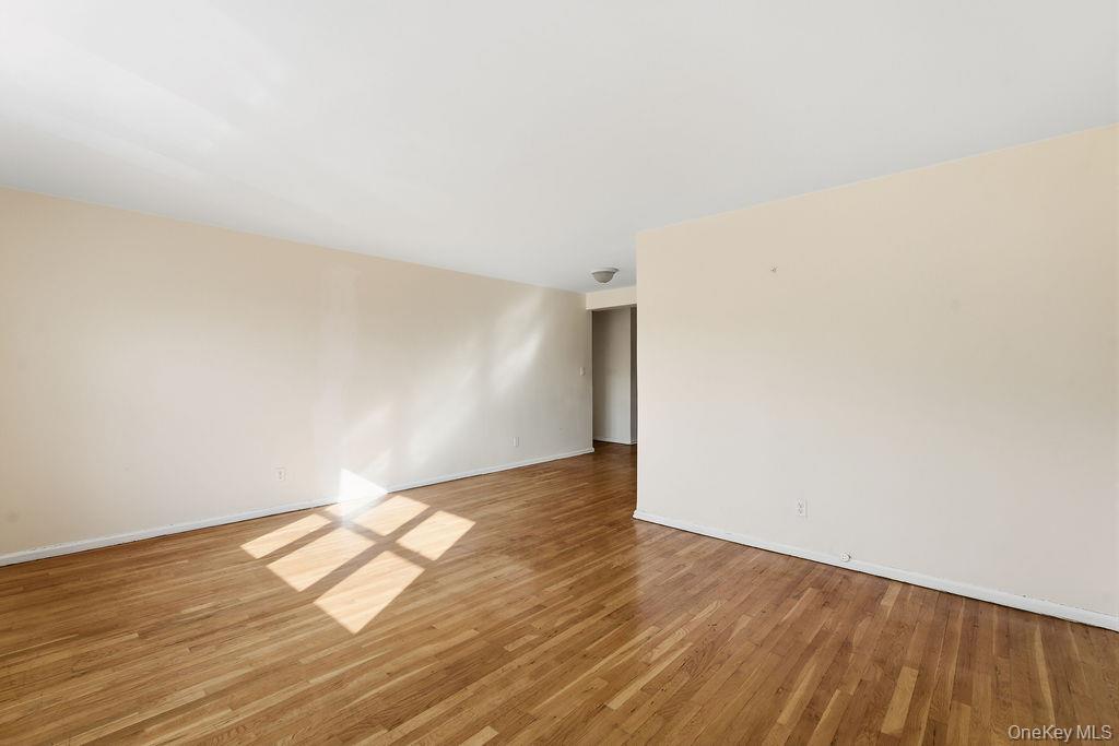 153-25 88th Street, Unit 4N Queens, NY 11414 - Photo 4 of 11 a view of empty room with wooden floor