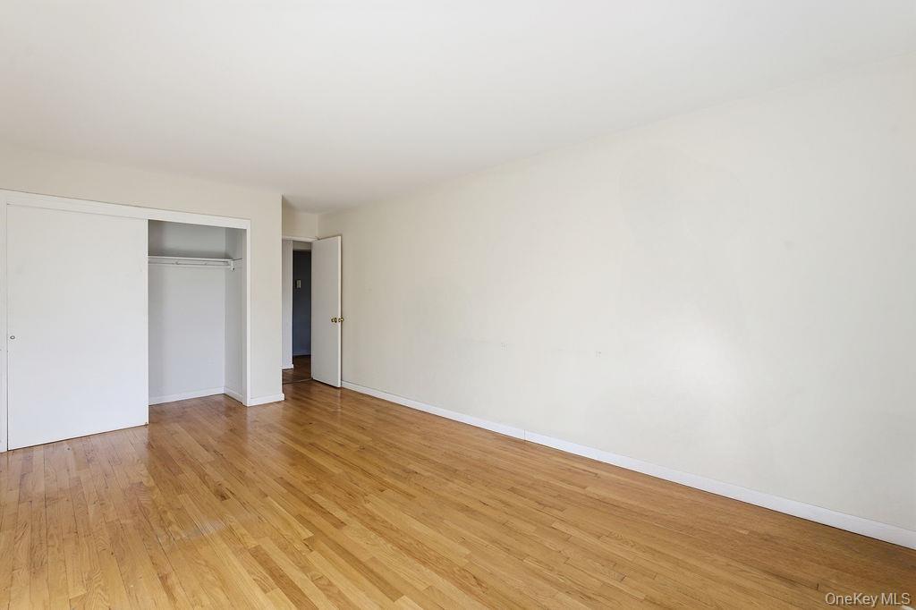 153-25 88th Street, Unit 4N Queens, NY 11414 - Photo 5 of 11 a view of an empty room with wooden floor