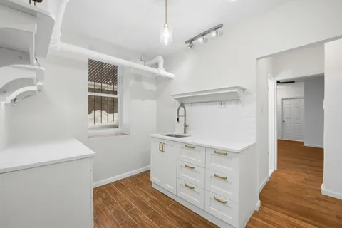 a view of hallway with wooden floor