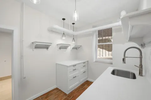 a kitchen with cabinets and window