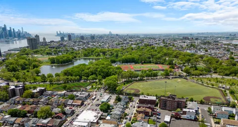 an aerial view of a houses with a lake