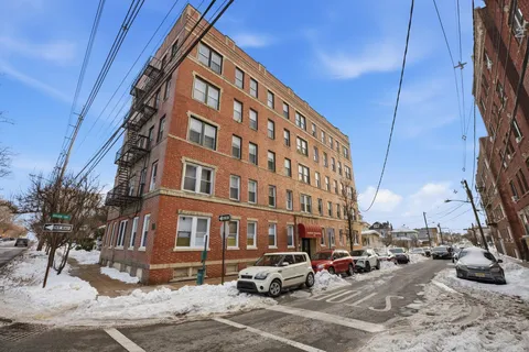 a buildings with car parked in front of it
