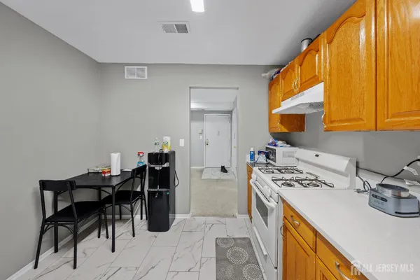 a kitchen that has a sink and a stove in it