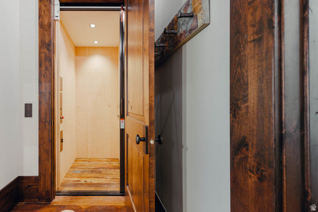 1667 West Tollgate Cyn Road Coalville, UT 84017 - Photo 48 of 61 Interior elevator featuring light wood-finish walls and reclaimed wood-finish flooring