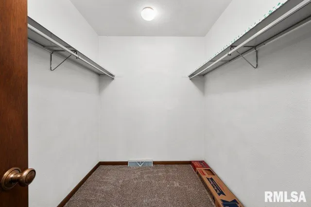 a view of an empty room with a fireplace