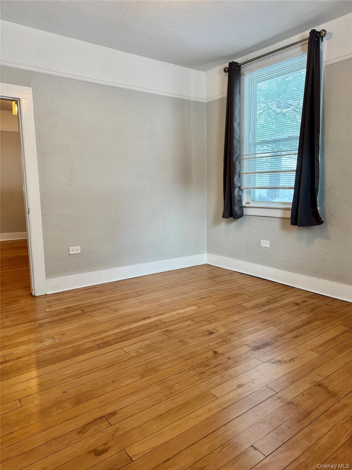 110 Titicus Road North Salem, NY 10560 - Photo 5 of 12 a view of an empty room with wooden floor and a window