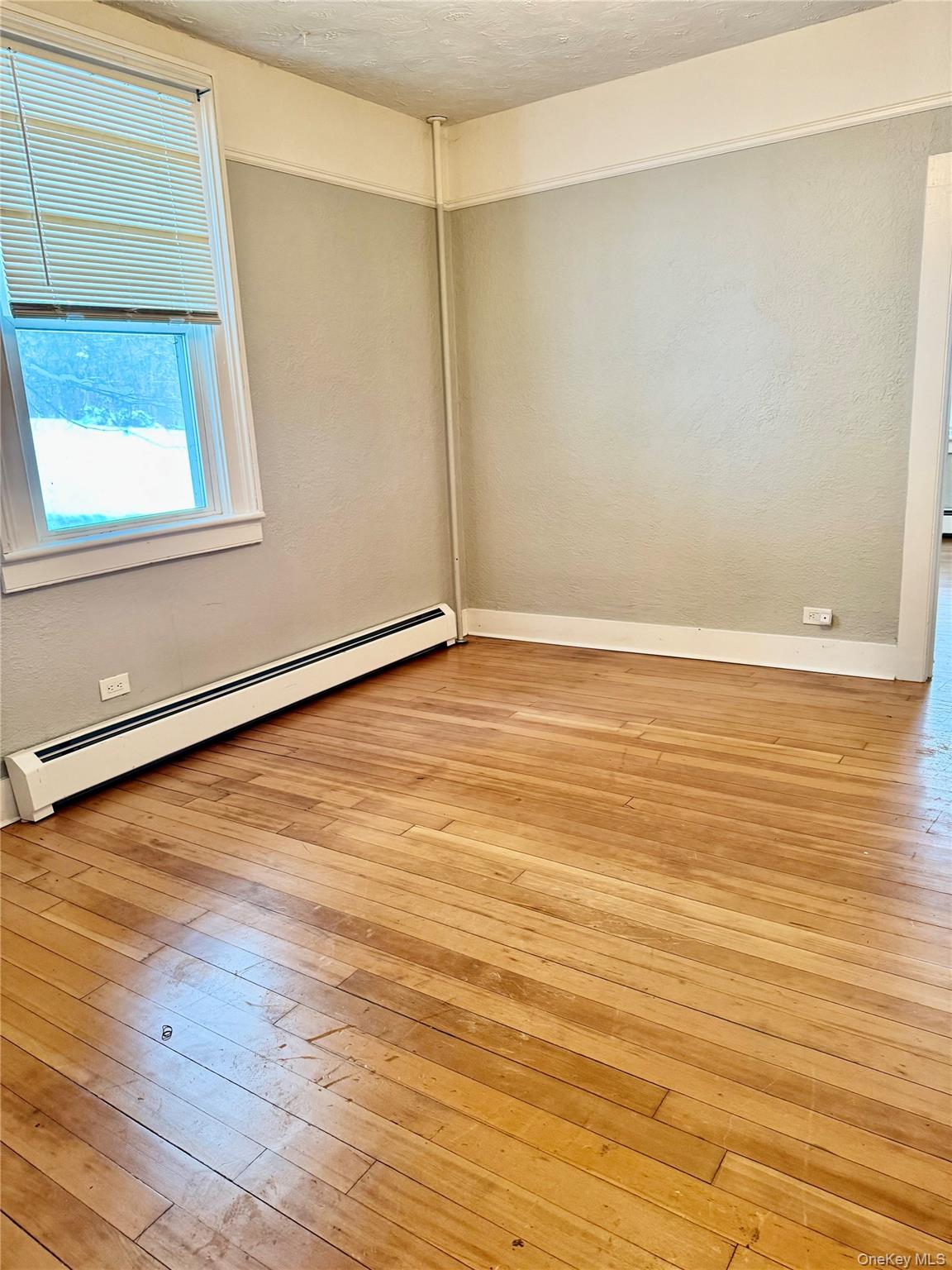 110 Titicus Road North Salem, NY 10560 - Photo 6 of 12 a view of an empty room with wooden floor and a window