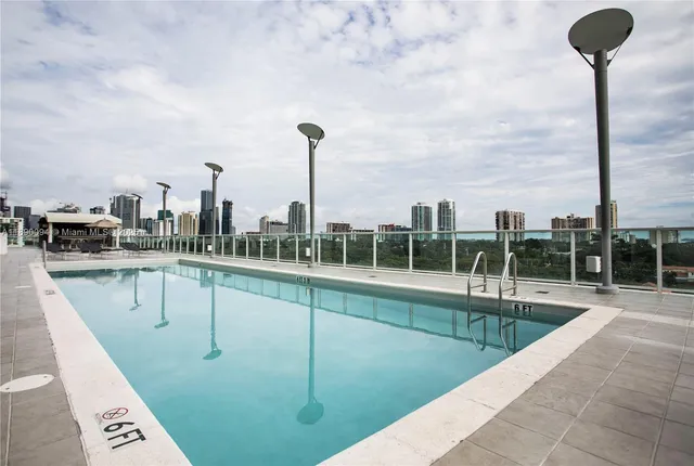 a view of a swimming pool with a lounge chair