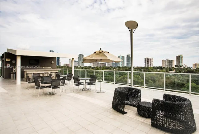 a roof deck with table and chairs