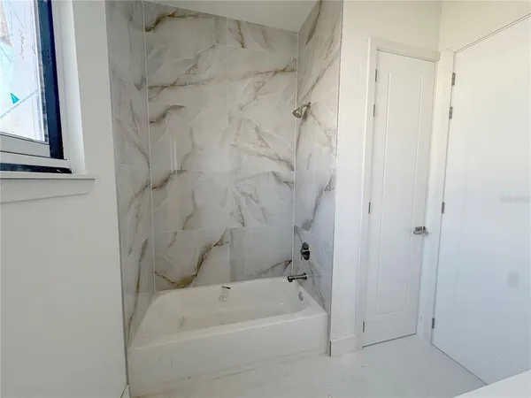 a bathroom with a bathtub and a shower