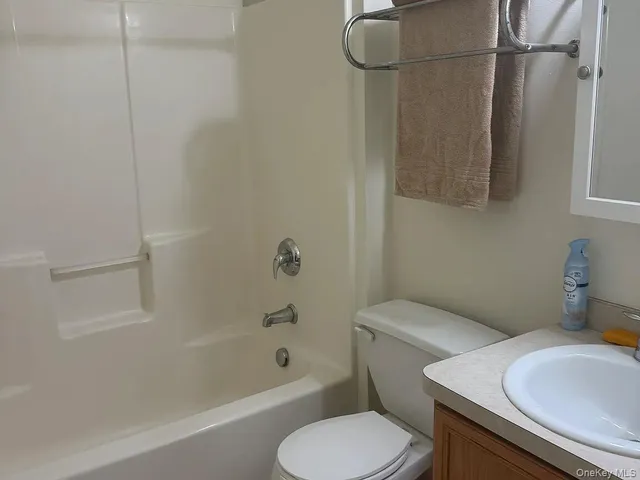 a white toilet sitting next to a bath tub
