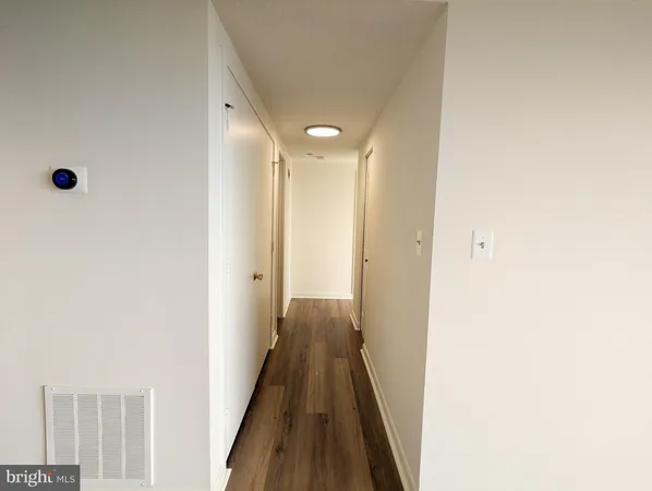 a view of a big room with wooden floor and cabinet
