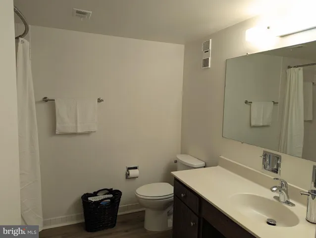 a bathroom with a shower curtain and a toilet