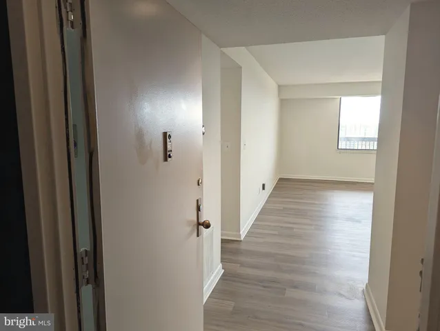 a view of empty room with wooden floor
