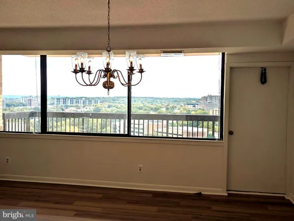 a view of a hallway with wooden floor and closet