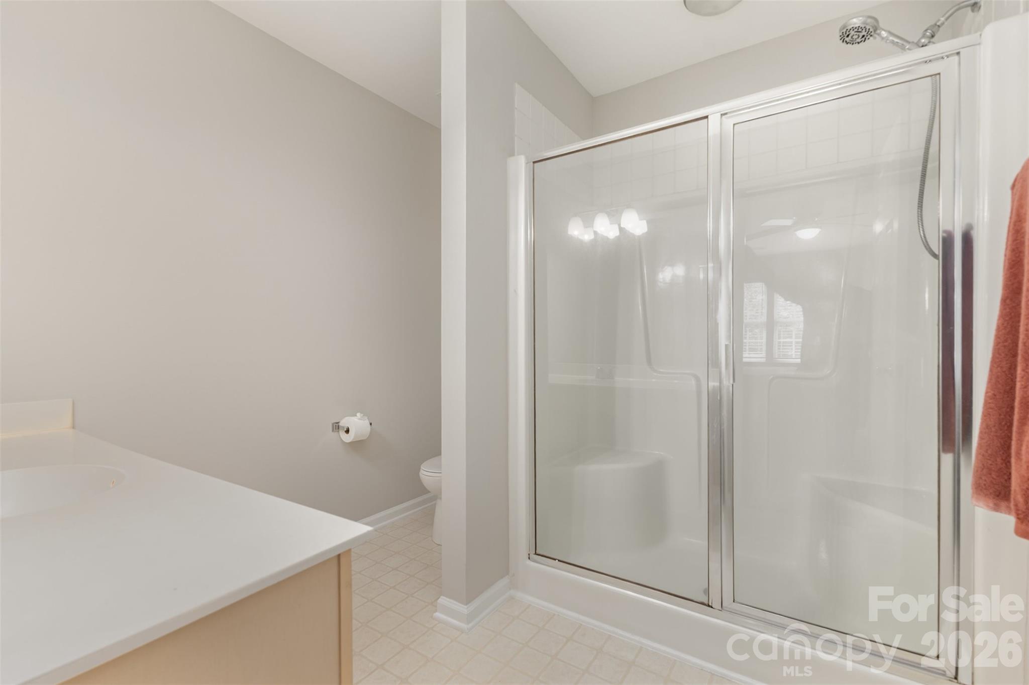 3832 Thomas Ridge Drive Charlotte, NC 28269 - Photo 16 of 33 a bathroom with a glass shower door