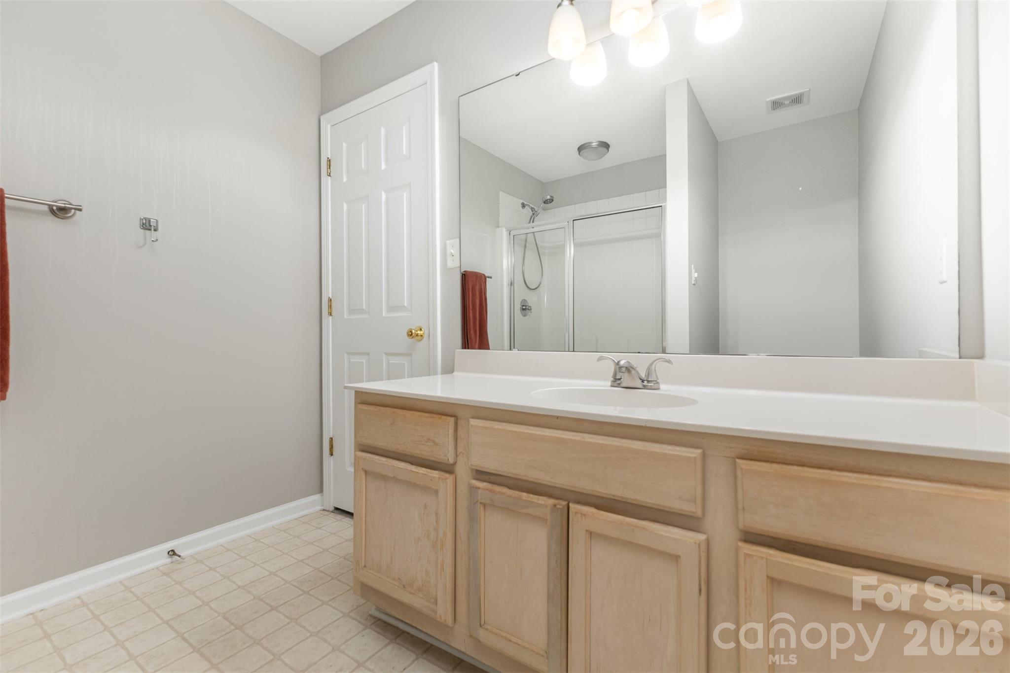 3832 Thomas Ridge Drive Charlotte, NC 28269 - Photo 17 of 33 a bathroom with a double vanity sink and a mirror