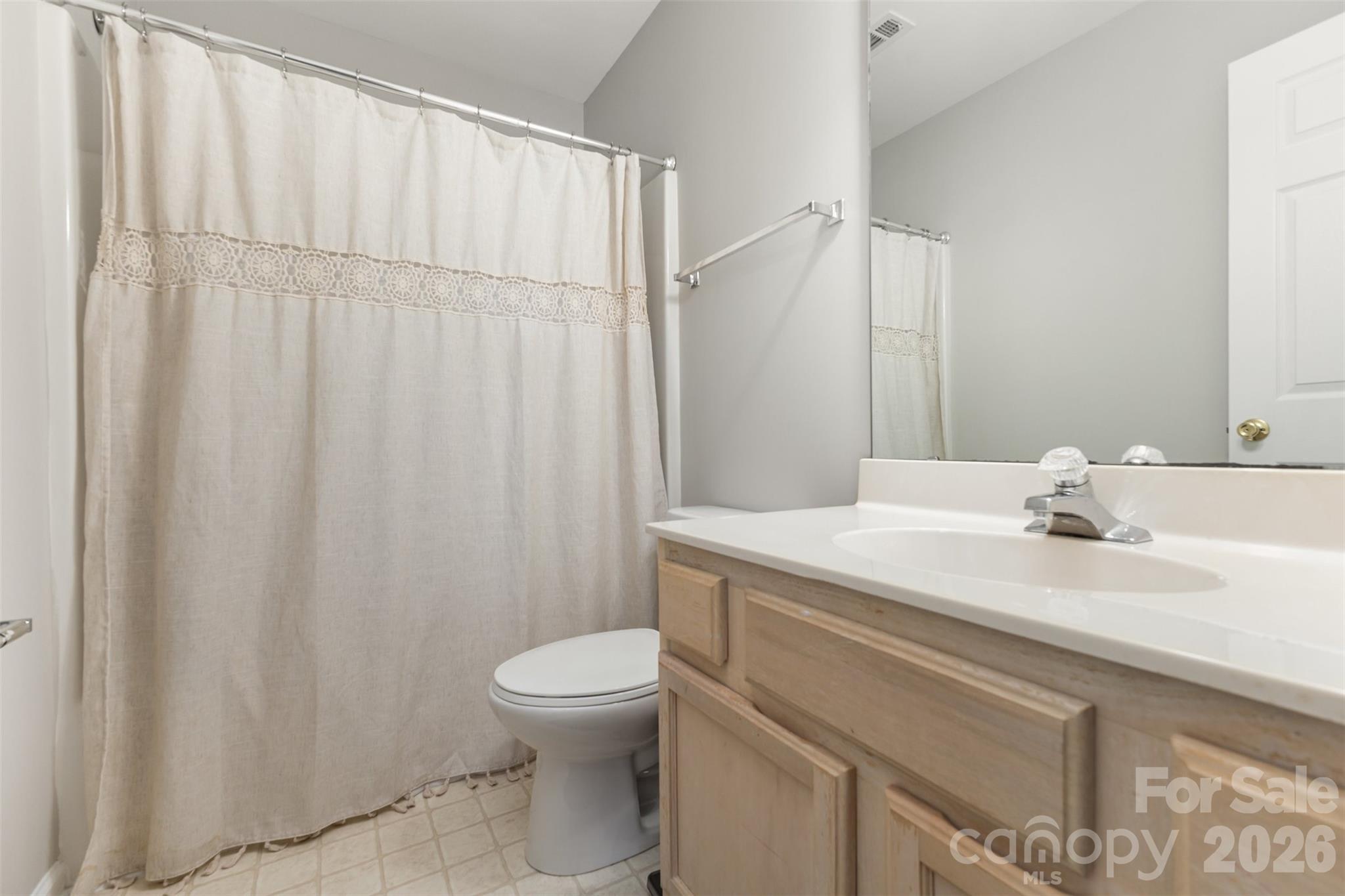3832 Thomas Ridge Drive Charlotte, NC 28269 - Photo 23 of 33 a bathroom with a sink a toilet and a mirror
