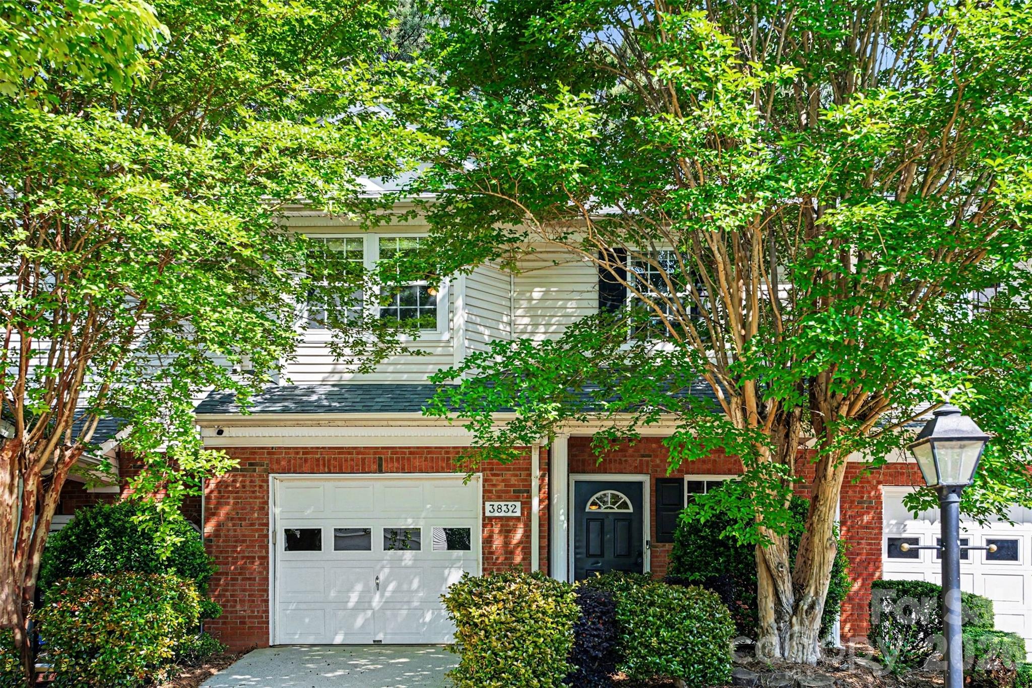 3832 Thomas Ridge Drive Charlotte, NC 28269 - Photo 24 of 33 a front view of a house with plants and trees