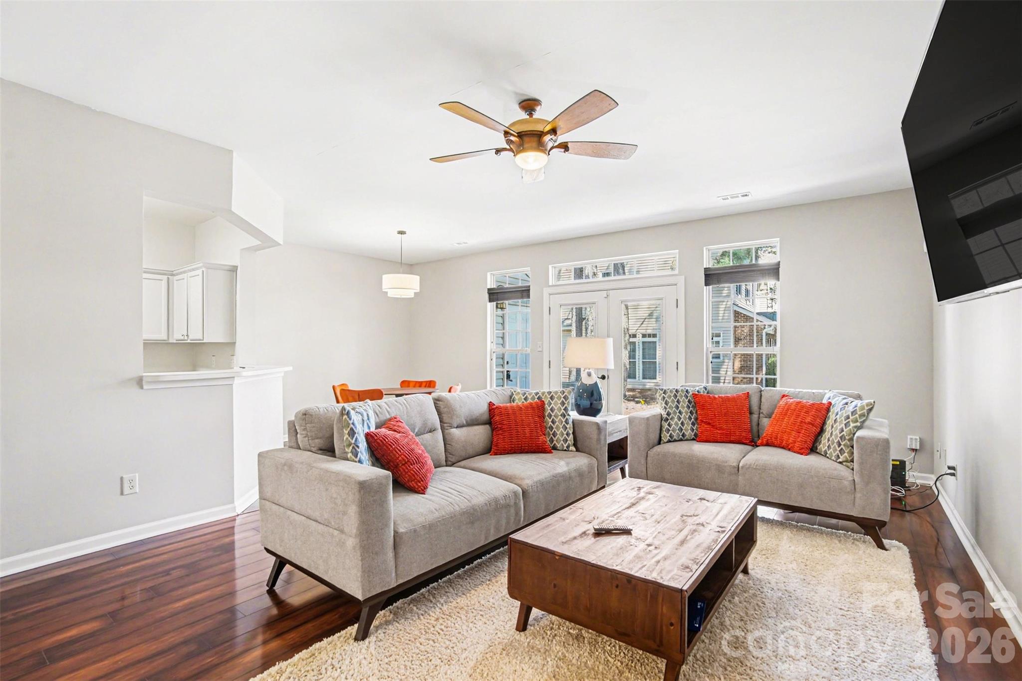 3832 Thomas Ridge Drive Charlotte, NC 28269 - Photo 27 of 33 a living room with furniture a rug and a flat screen tv