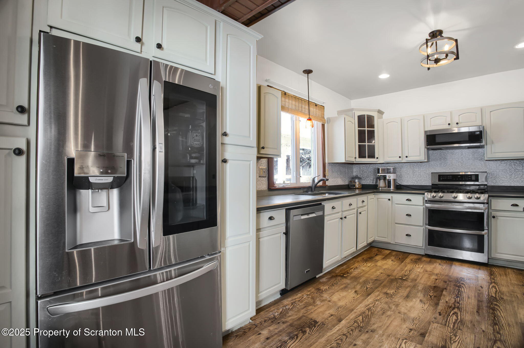 654 Cribbs Road Poyntelle, PA 18454 - Photo 11 of 67 a kitchen with granite countertop a refrigerator stove and sink