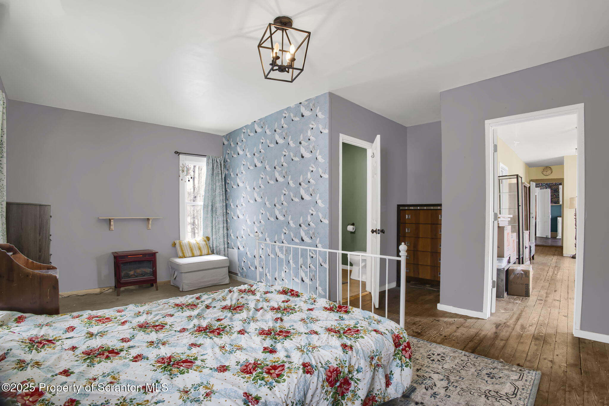 654 Cribbs Road Poyntelle, PA 18454 - Photo 23 of 67 a bedroom with a bed and wooden floor