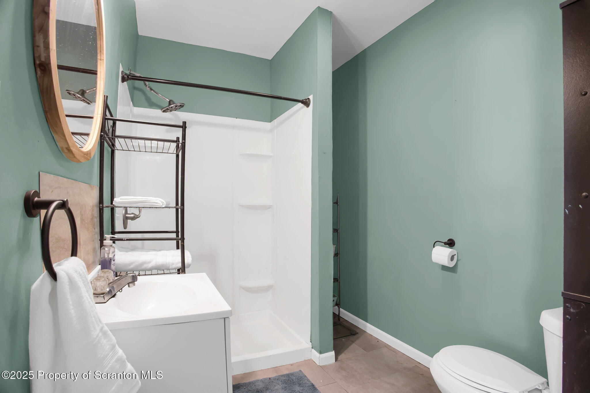 654 Cribbs Road Poyntelle, PA 18454 - Photo 25 of 67 a bathroom with a toilet sink and mirror