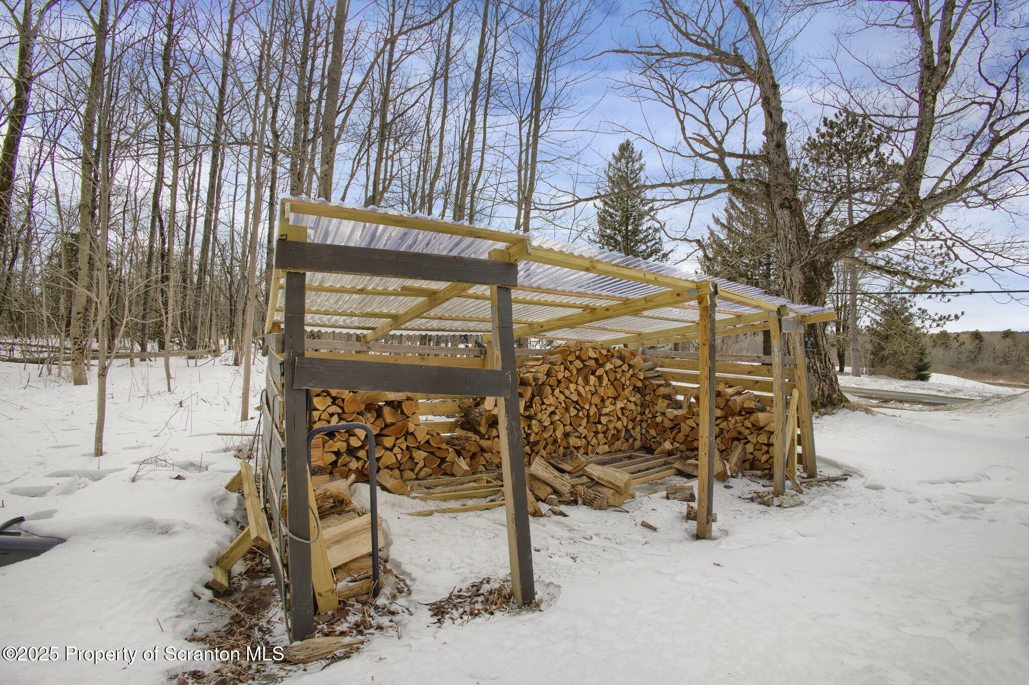 654 Cribbs Road Poyntelle, PA 18454 - Photo 57 of 67 a view of a bench under a large tree