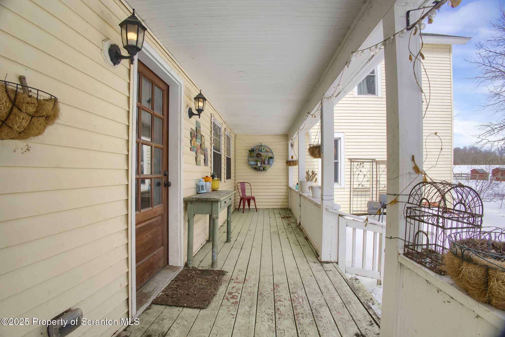 654 Cribbs Road Poyntelle, PA 18454 - Photo 65 of 67 a view of a balcony with wooden floor and furniture