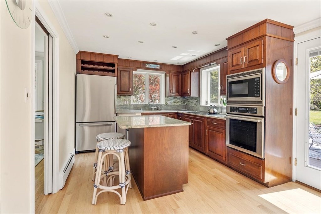 21 Berkley Circle Hingham, MA 02043 - Photo 11 of 34 a kitchen with stainless steel appliances granite countertop a refrigerator a stove a sink and a microwave