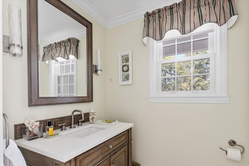 21 Berkley Circle Hingham, MA 02043 - Photo 13 of 34 a bathroom with a sink a mirror and a window