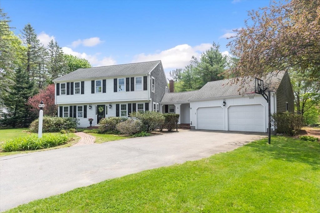 21 Berkley Circle Hingham, MA 02043 - Photo 2 of 34 a front view of a house with a garden and trees