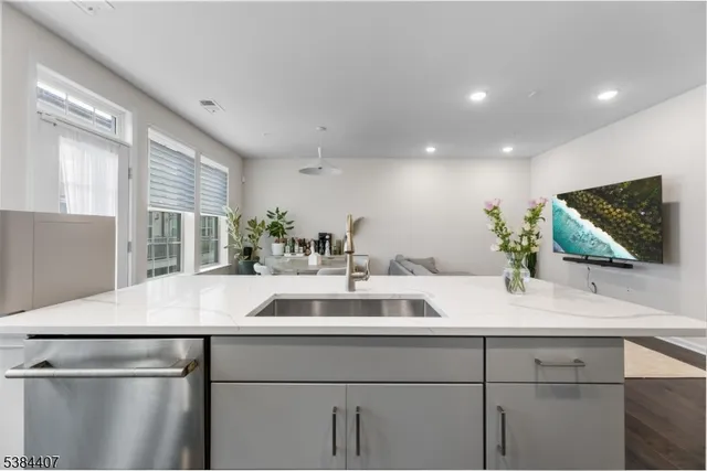 a kitchen with stainless steel appliances a stove microwave and sink