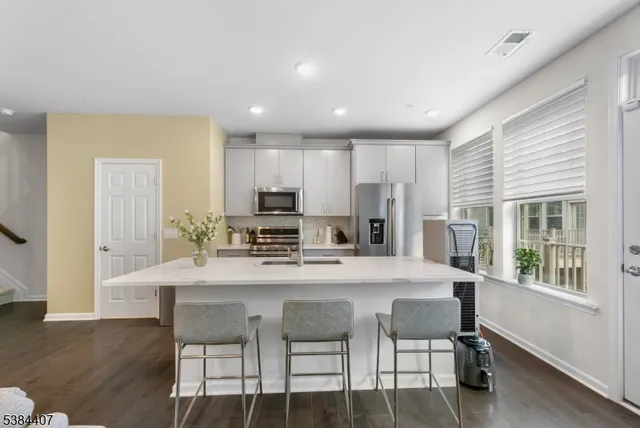 a living room with furniture kitchen and a table