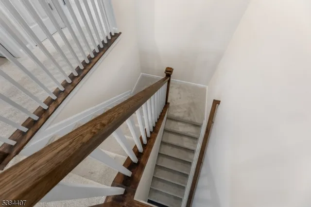 a living room with furniture a flat screen tv and a potted plant