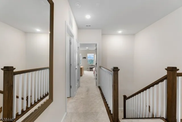 a bathroom with a sink a toilet a mirror and shower curtain