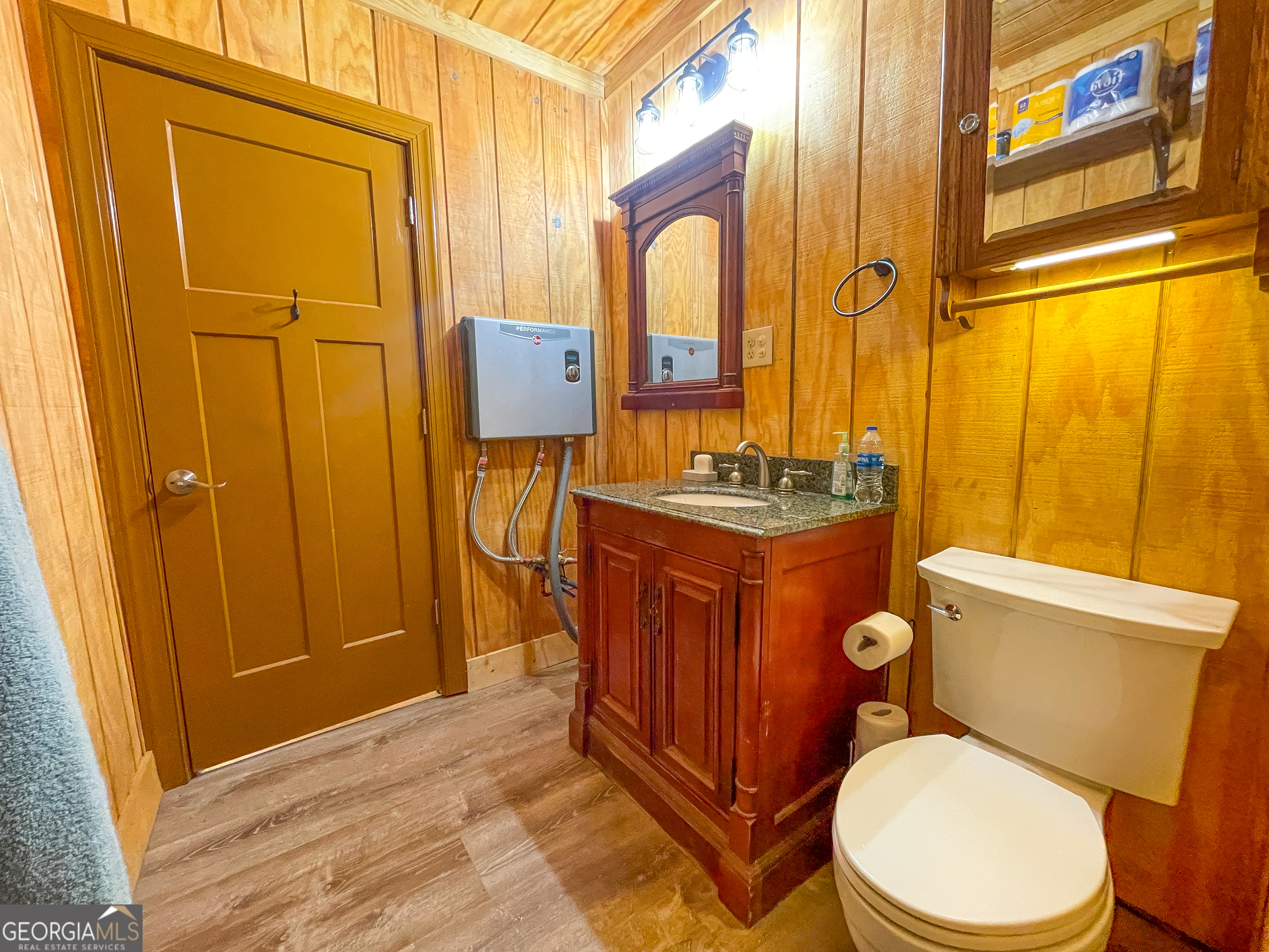 65 Acres On Half Mile Road Lyerly, GA 30730 - Photo 18 of 51 a bathroom with a granite countertop toilet sink and mirror
