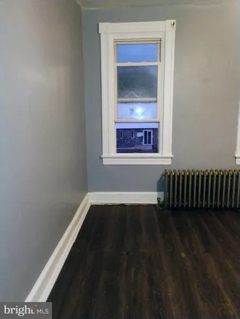 a view of a hallway with a livingroom and a bathroom