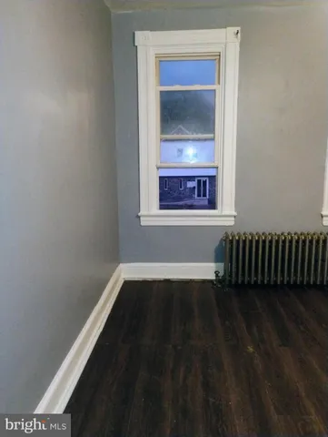 a view of a hallway with a livingroom and a bathroom