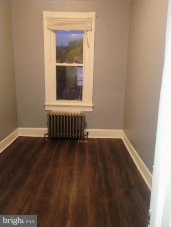 a room that has a window and wooden floor