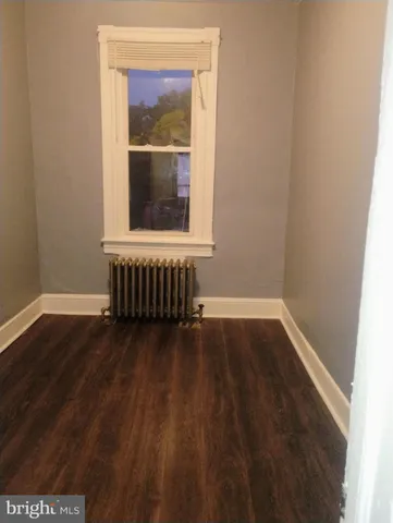 a room that has a window and wooden floor