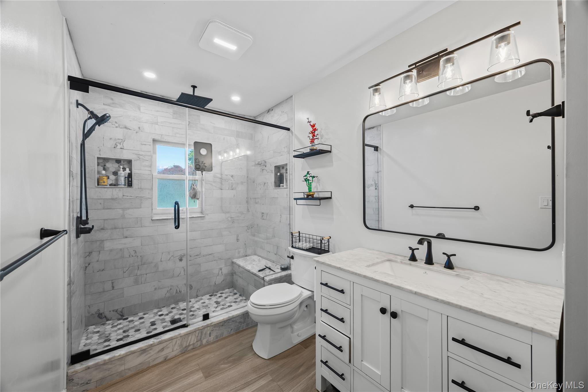 69 Silver Spring Road New Windsor, NY 12553 - Photo 10 of 20 a bathroom with a double vanity sink mirror double shower and a toilet