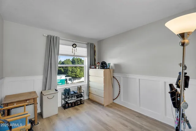 a bed sitting in a bedroom next to a window