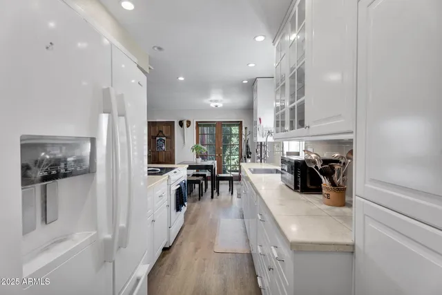 a kitchen with a sink stove and refrigerator