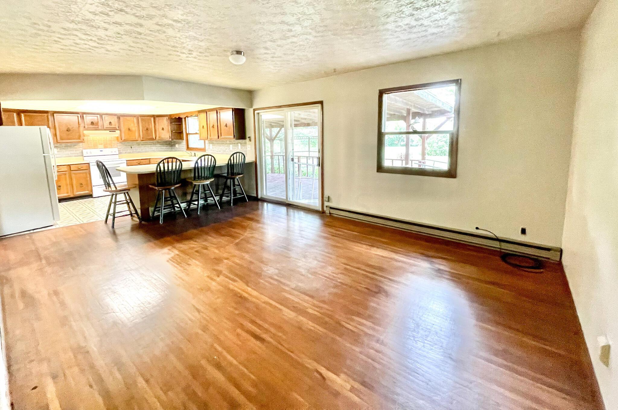 10671 Co Road East Liberty, OH 43319 - Photo 22 of 37 Kitchen and dining room area. Extra large peninsula and new interior wall paint.