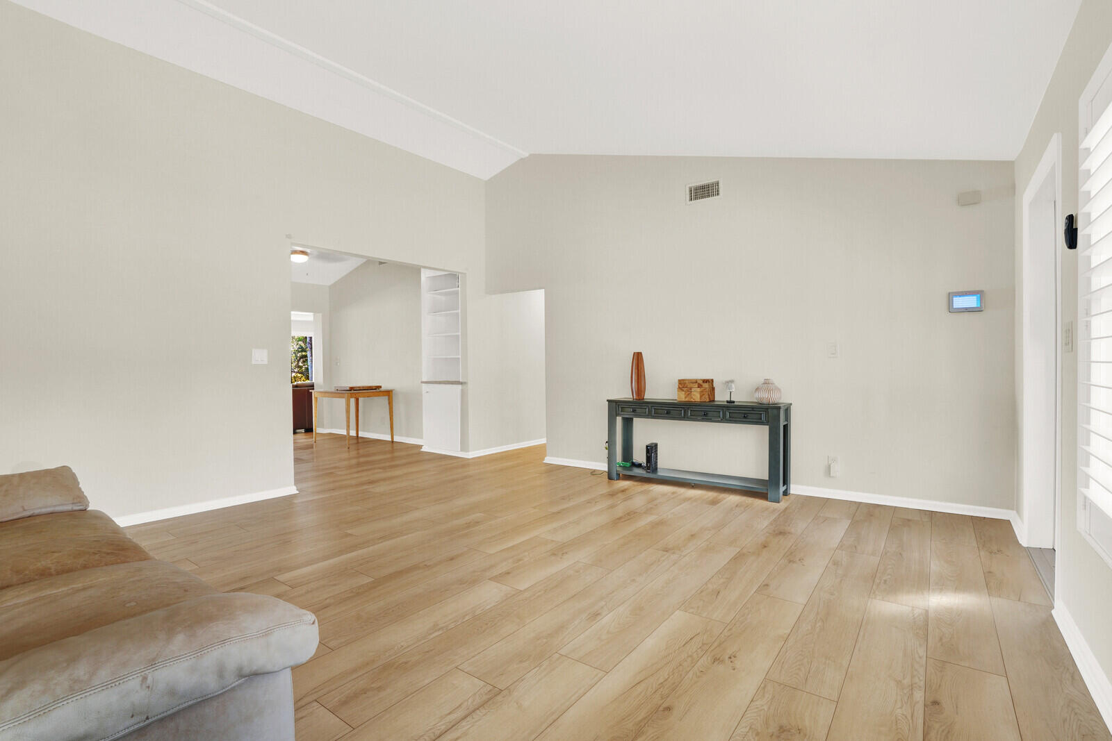 12980 Prosperity Farms Road Palm Beach Gardens, FL 33410 - Photo 11 of 55 a view of an empty room with wooden floor and a cabinet