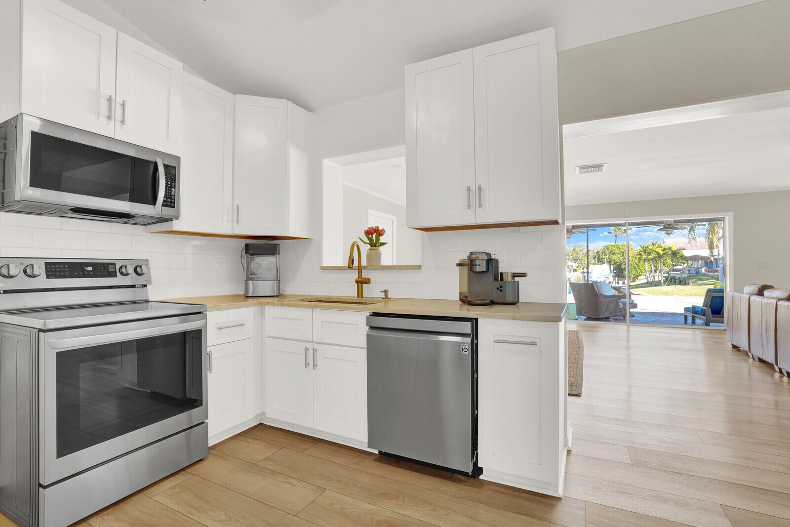 12980 Prosperity Farms Road Palm Beach Gardens, FL 33410 - Photo 13 of 55 a kitchen with stainless steel appliances granite countertop a stove microwave sink and cabinets